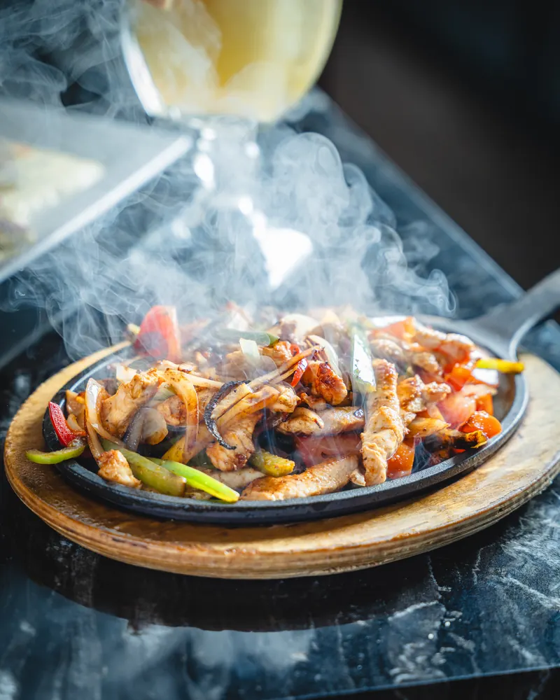 Fajitas on a sizzling skillet